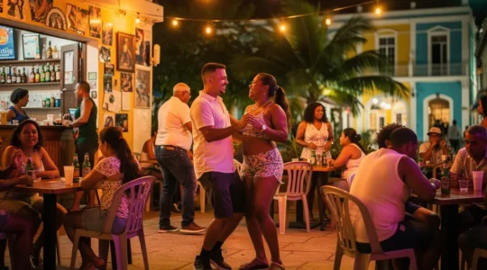Scène de vie nocturne dominicaine avec des personnes dansant le merengue dans un bar local animé